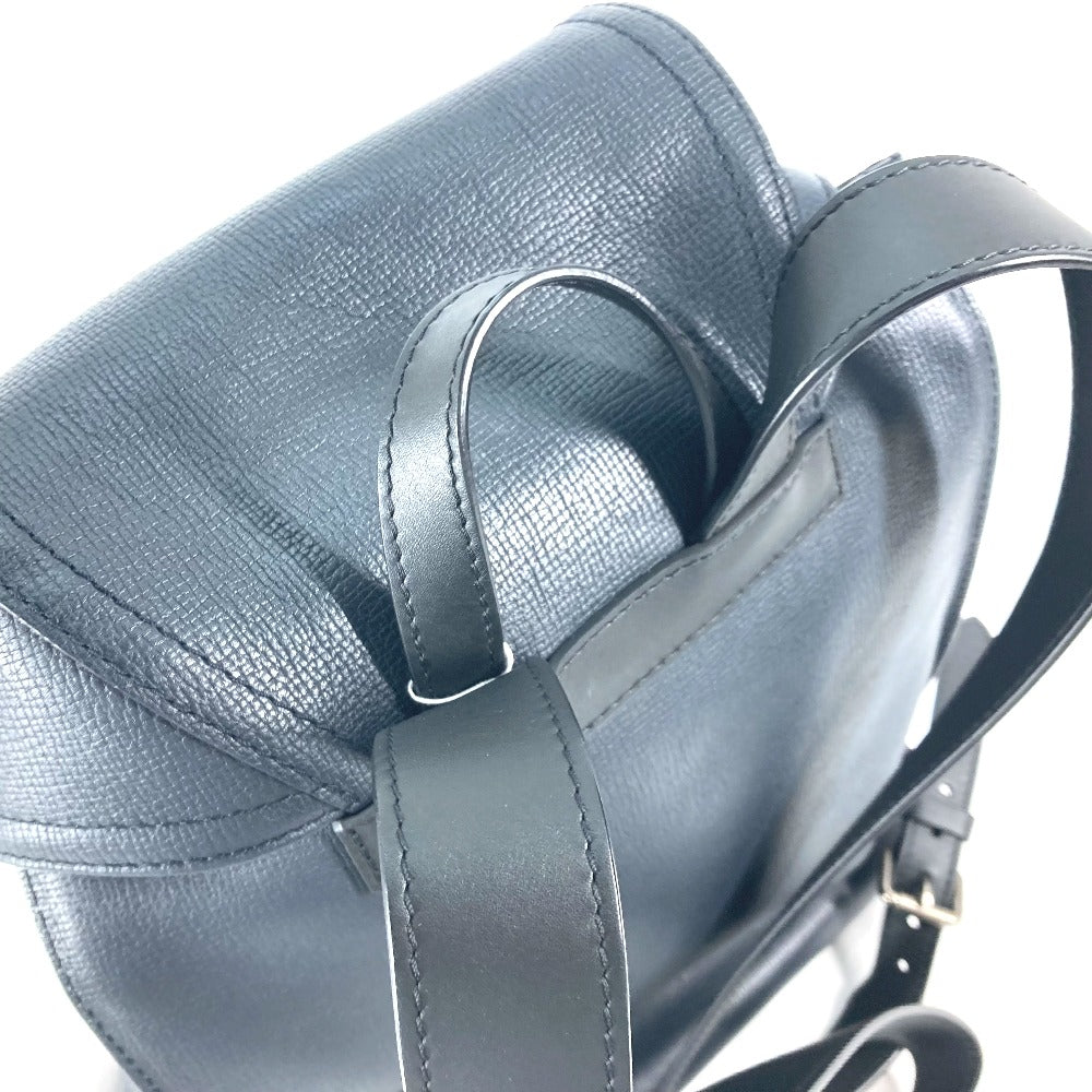 Close-up of a gray leather bag with a strap on a white background