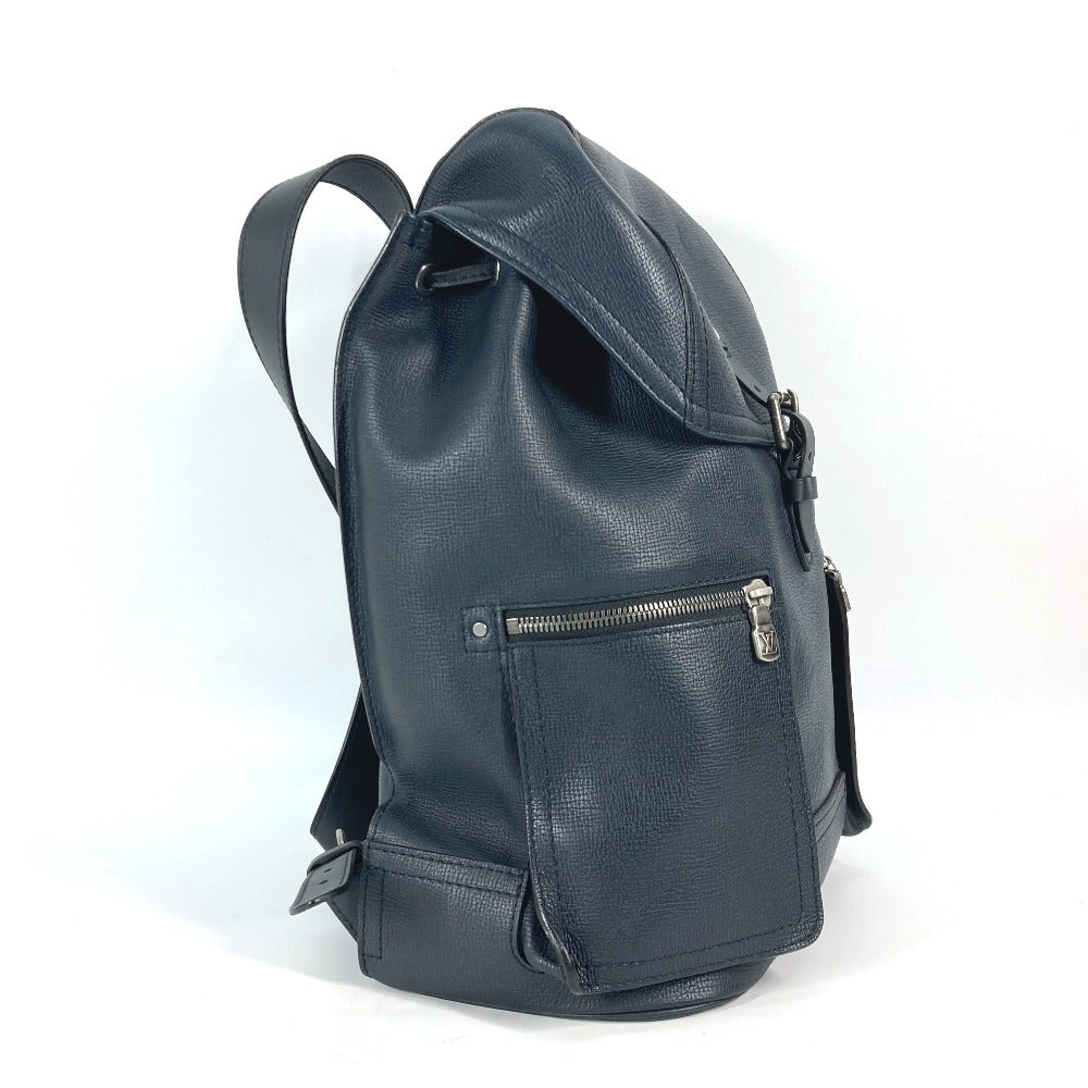 Black leather backpack with a front zipper pocket on a white background