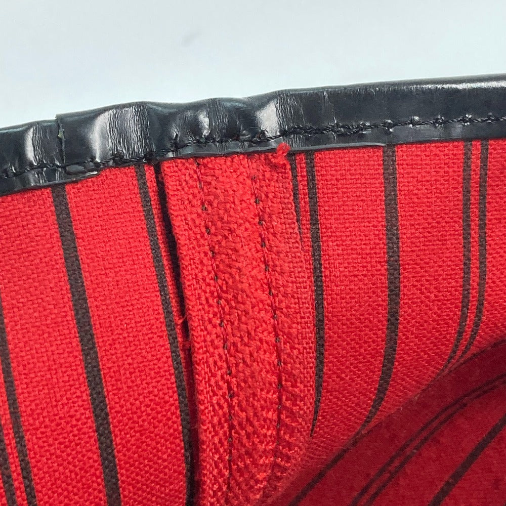 Close-up of red fabric with black stripes and a black border on a white background