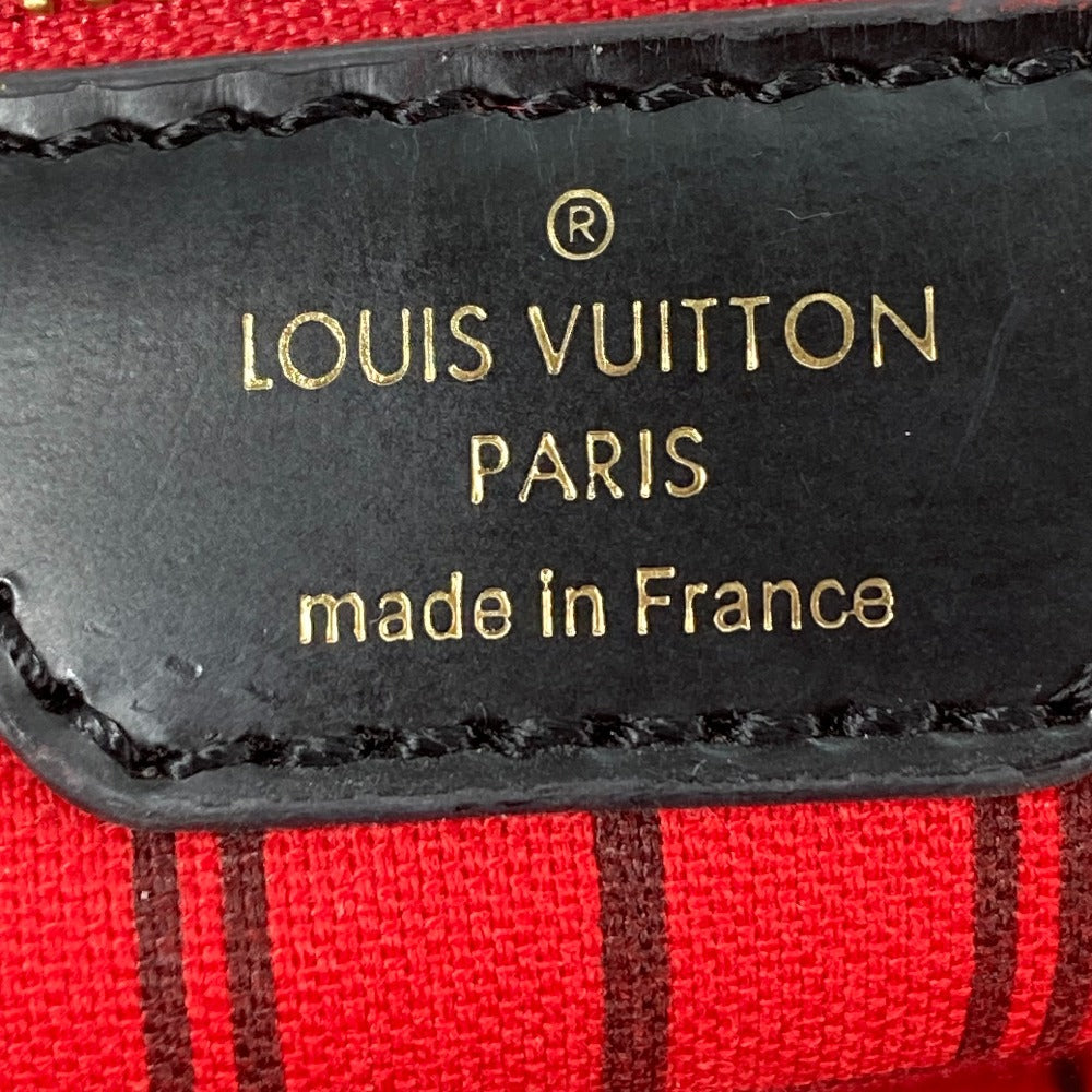 Louis Vuitton label on a red and black striped fabric background