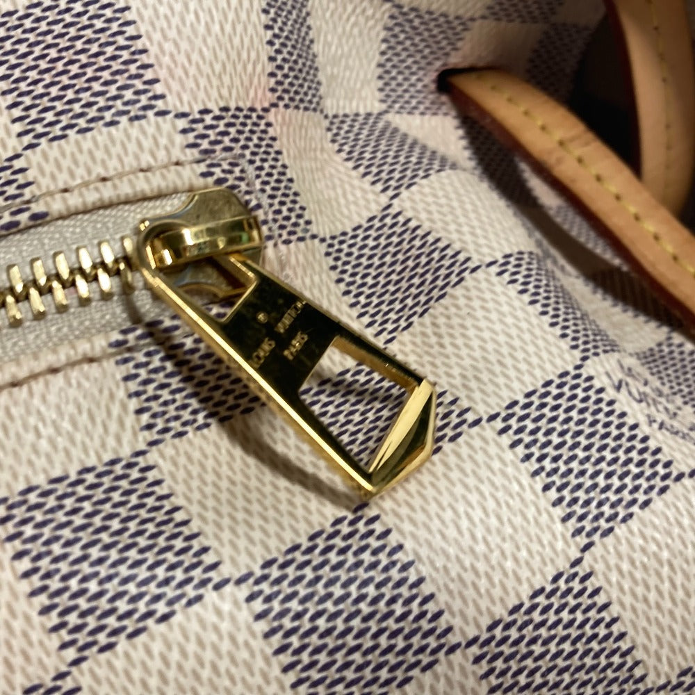 Close-up of a gold zipper on a patterned fabric background