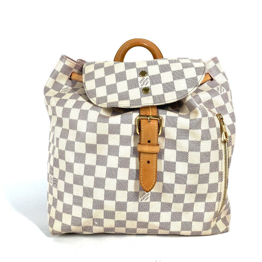 Checkered backpack with brown straps and buckle on a white background