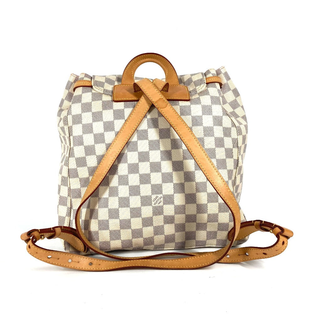 Checkered backpack with brown straps on a white background