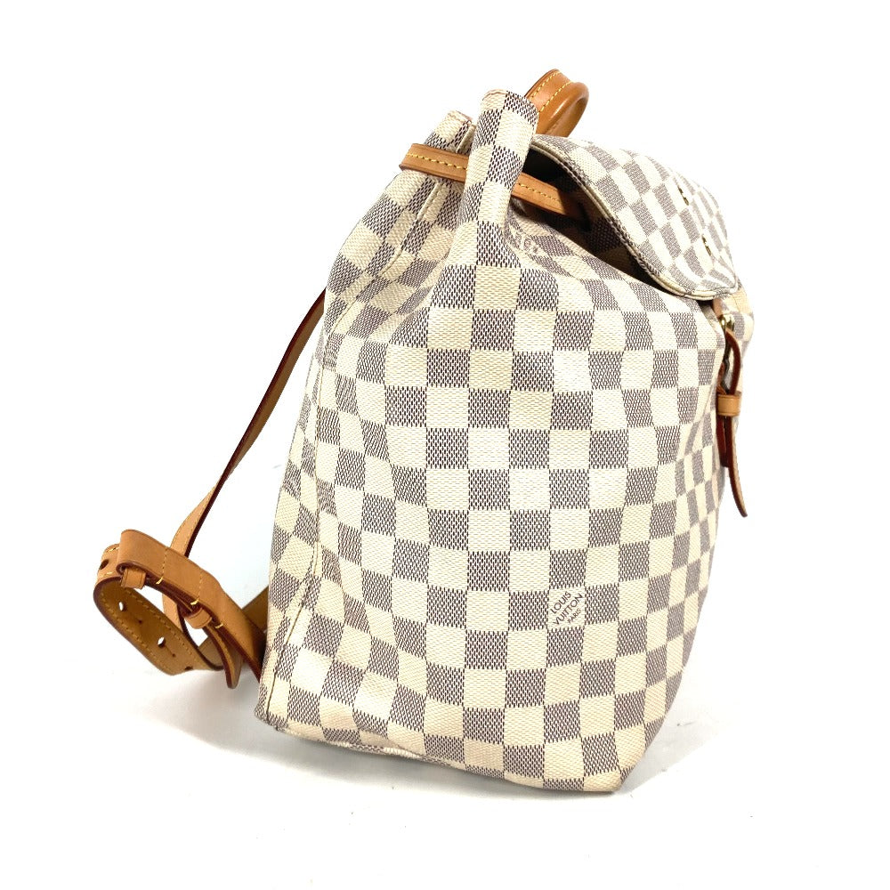 Checkered backpack with brown straps on a white background