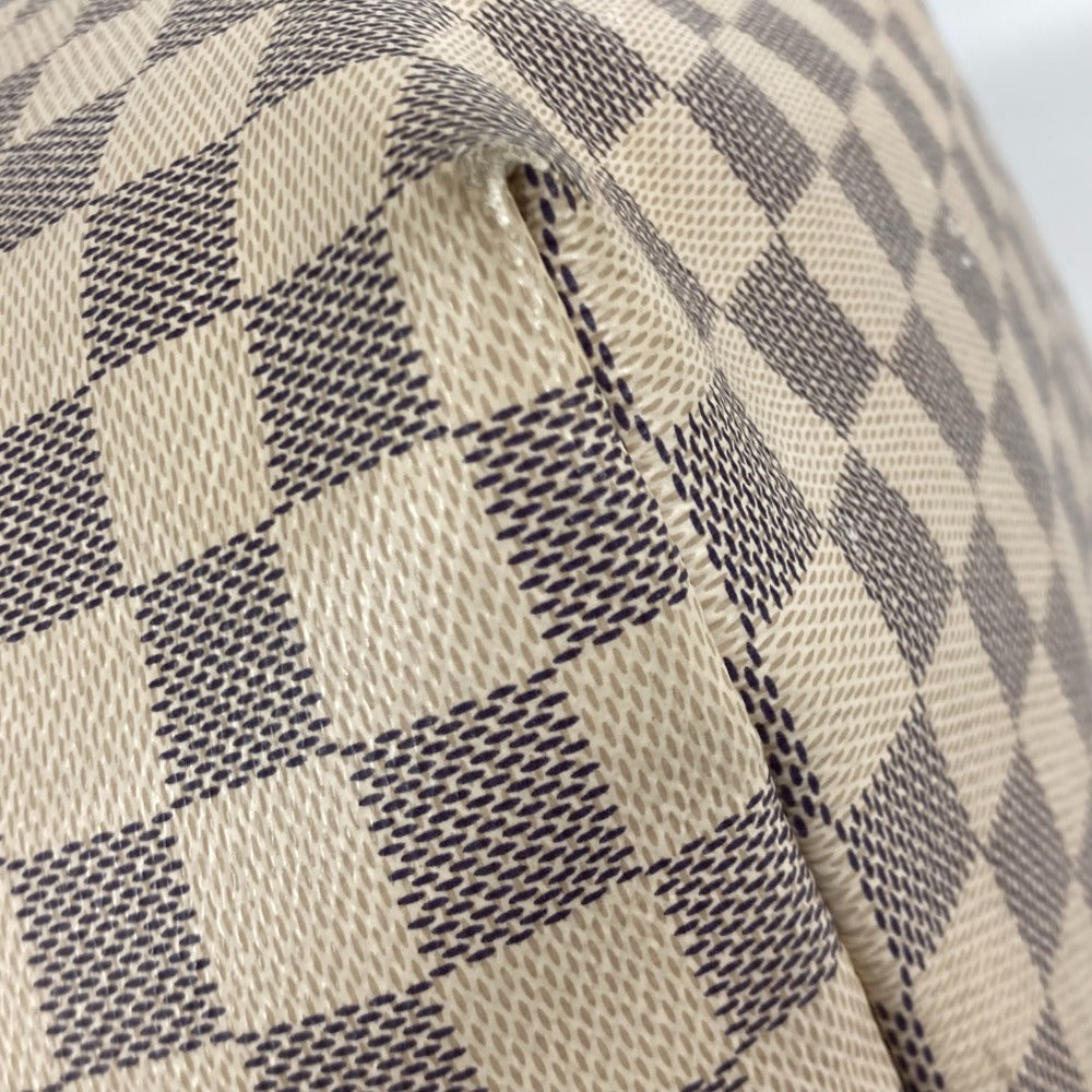Close-up of a checkered fabric with a beige and black pattern.