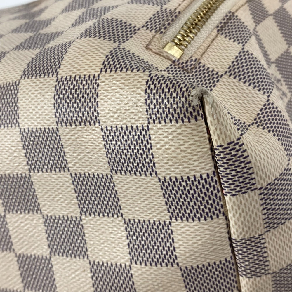 Close-up of a patterned bag with a gold zipper.