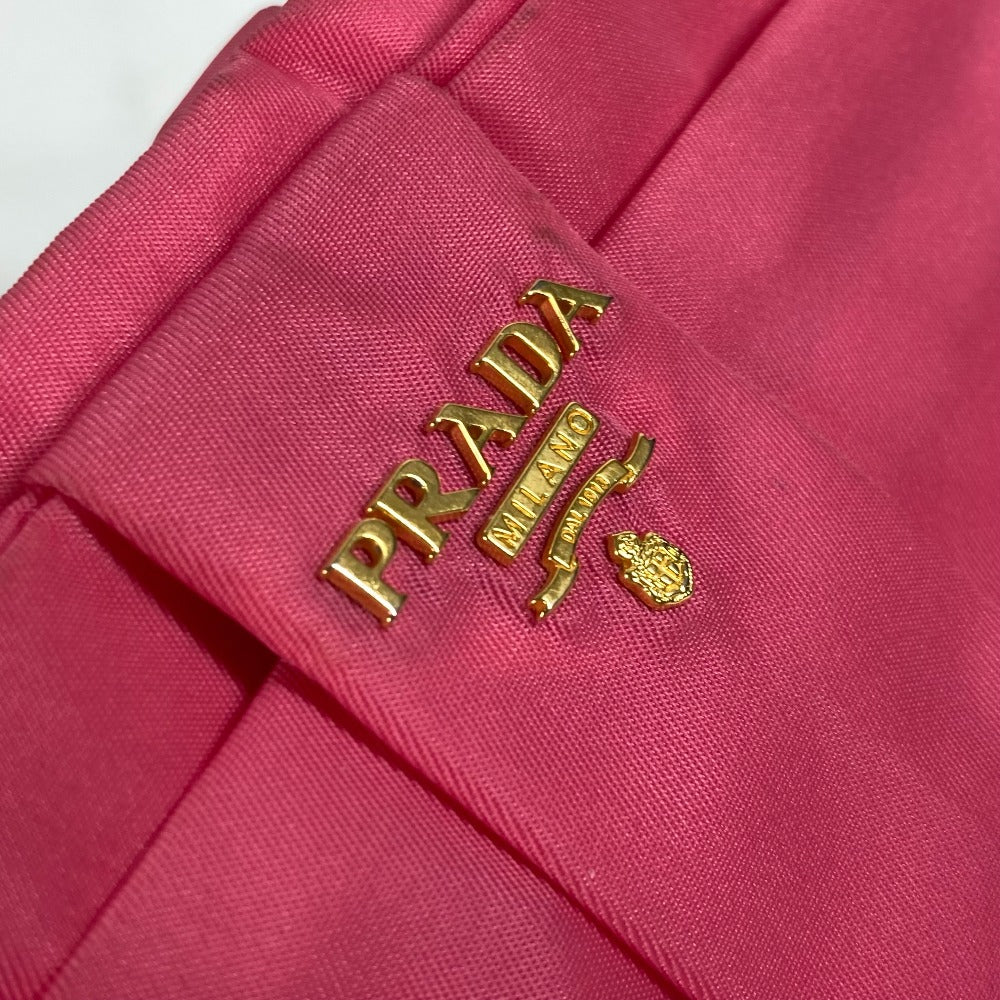 Close-up of a Prada logo on a pink fabric background