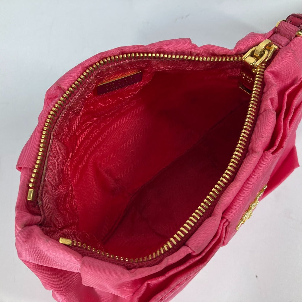 Pink handbag with gold zipper on a white background