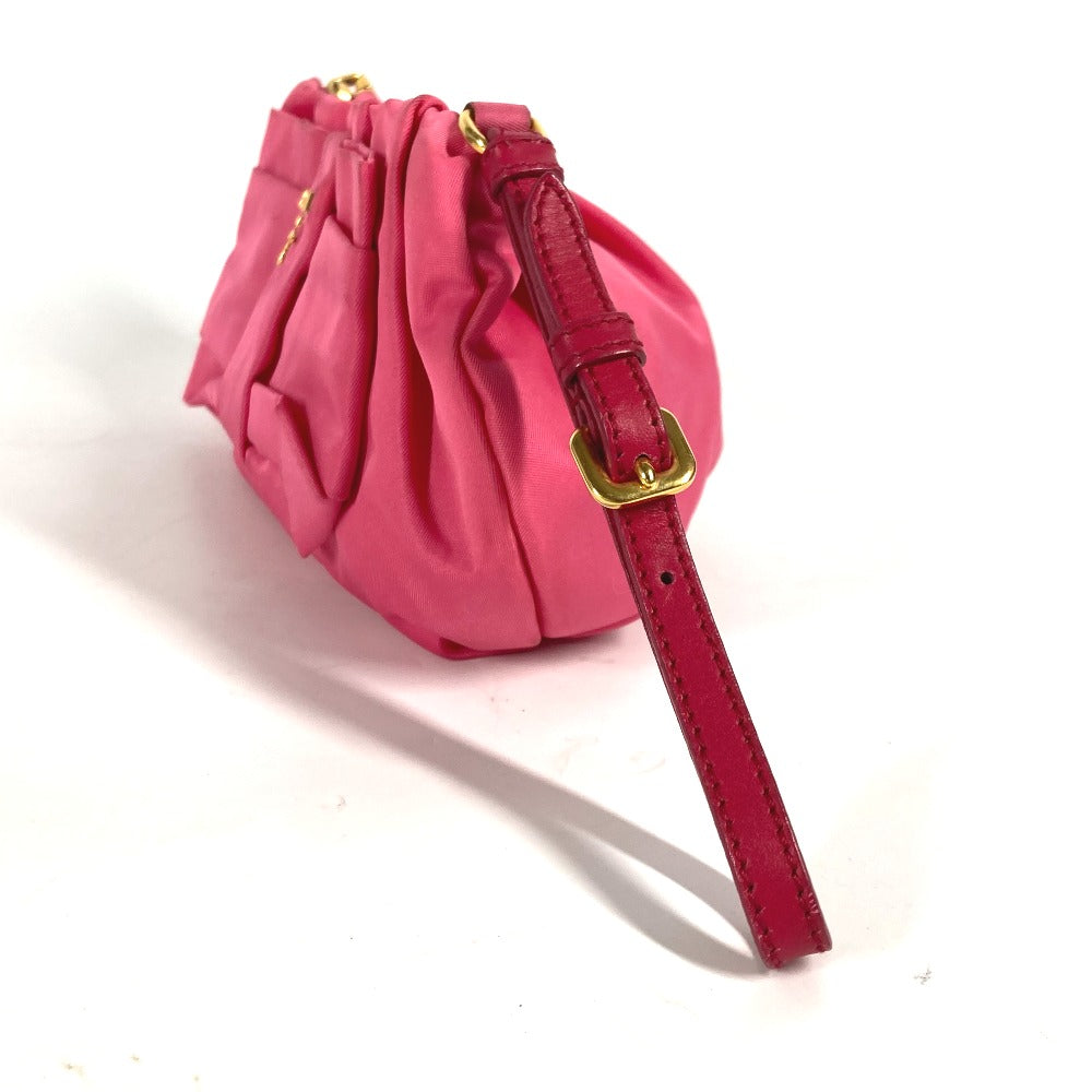 Pink drawstring bag with a red strap on a white background