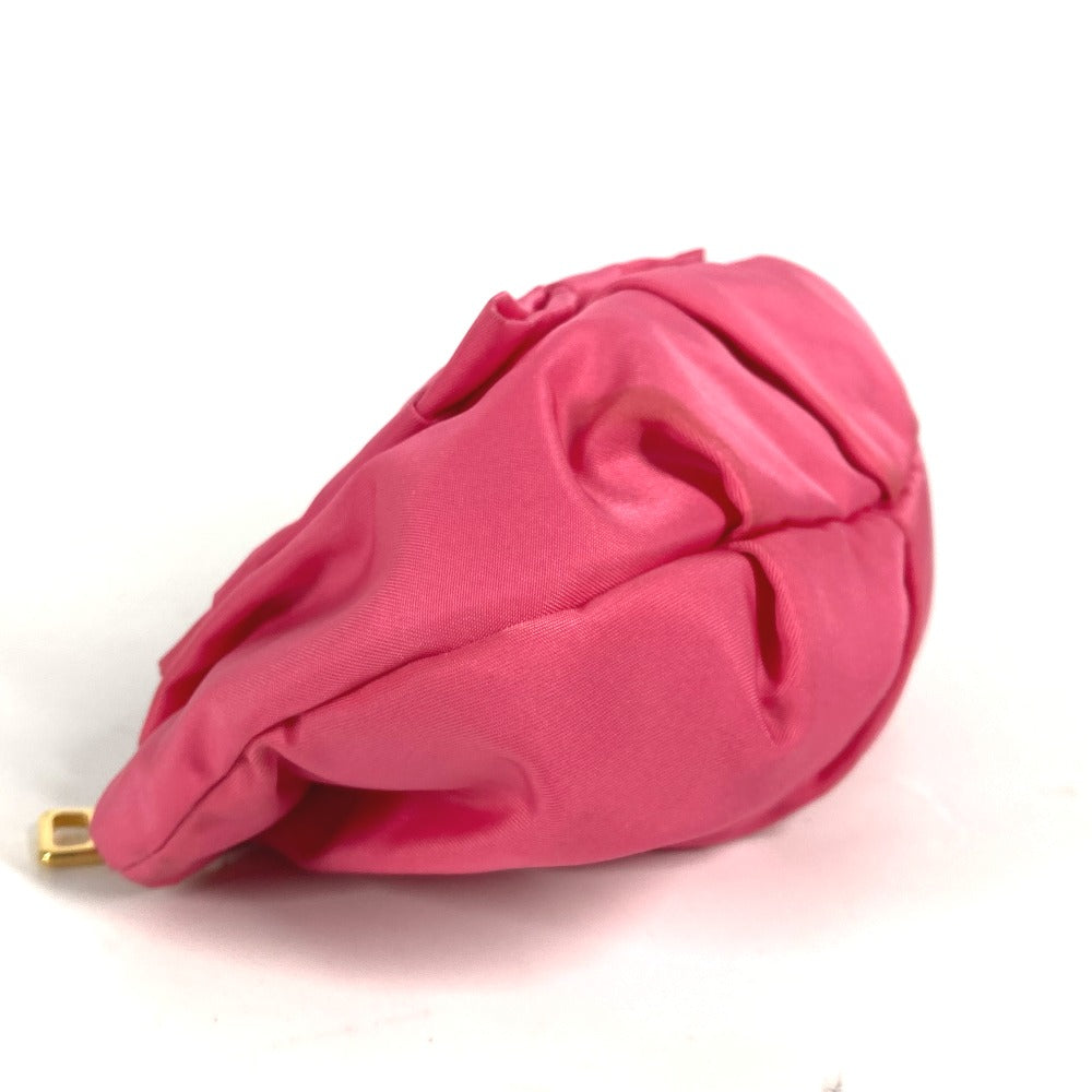 Pink fabric pouch with a gold clasp on a white background