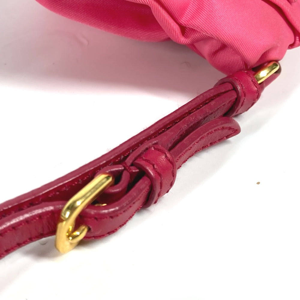 Close-up of a pink handbag with a gold clasp on a white background