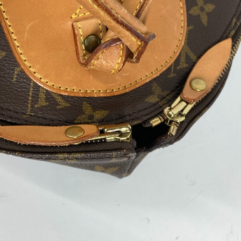 Close-up of a brown leather handbag with gold hardware on a white background
