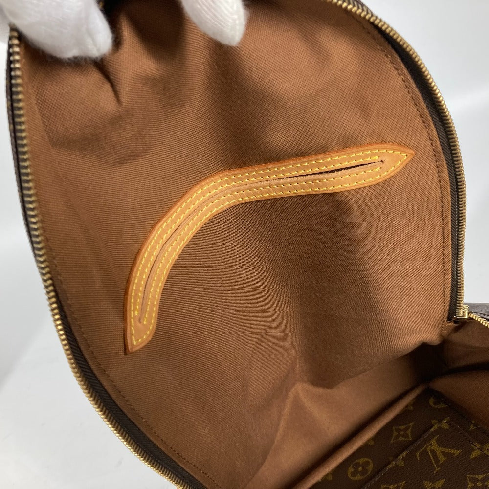 Close-up of a brown fabric bag with gold stitching on a white background