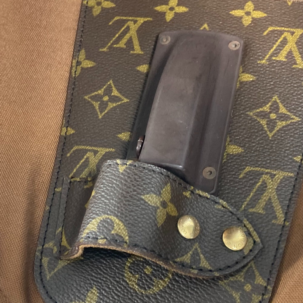 Black knife sheath with gold accents on a patterned surface