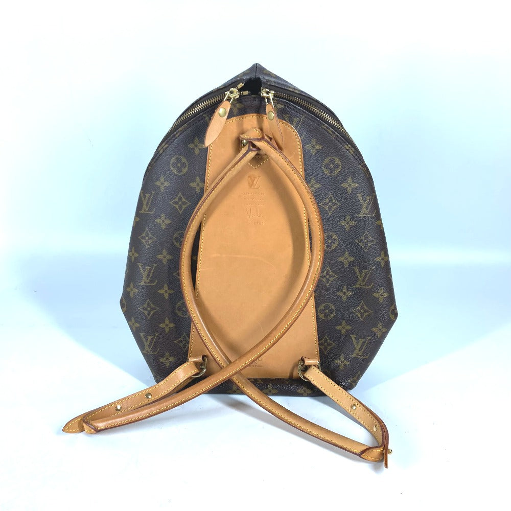 Designer handbag with monogram pattern on a light blue background