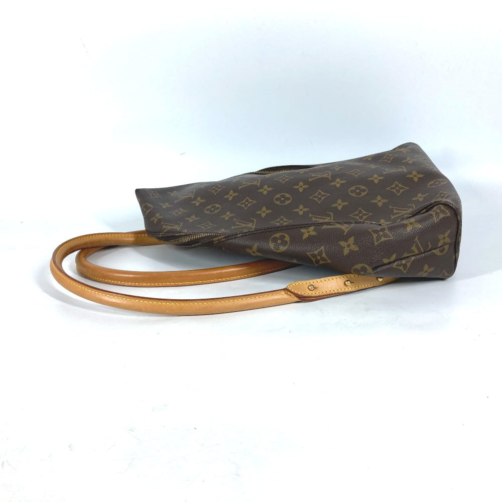 Brown monogram handbag with tan handle on a white background
