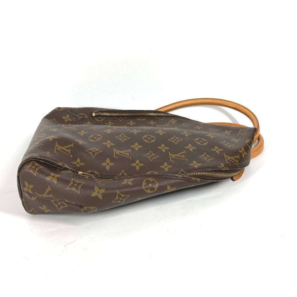 Brown handbag with monogram pattern on a white background