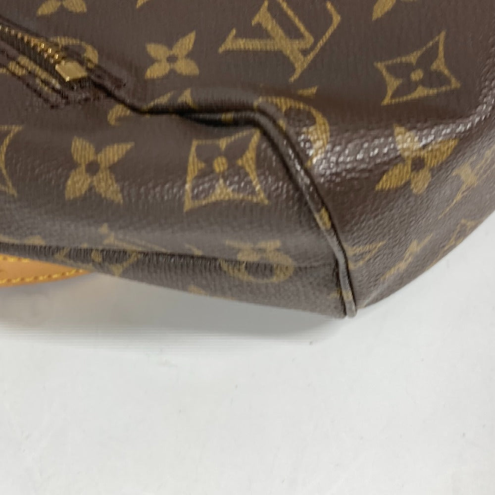 Close-up of a brown Louis Vuitton monogram handbag on a white background