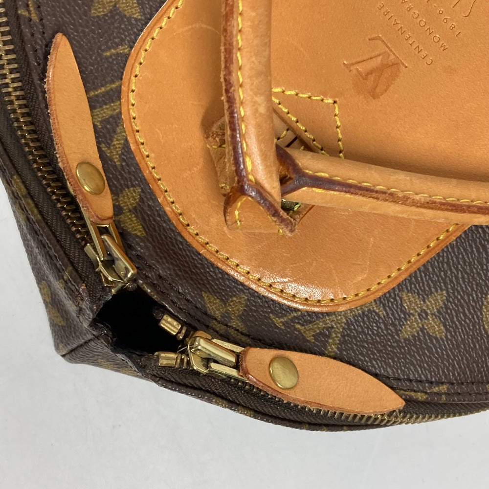 Close-up of a brown leather bag with gold accents on a white background