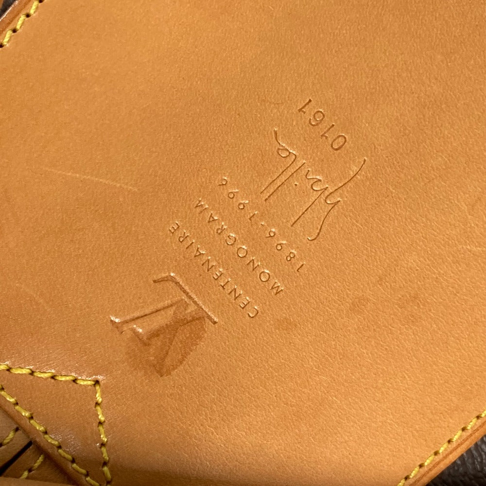 Close-up of a brown leather product with branding and stitching details.