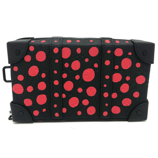 Black bag with red polka dot pattern on a white background