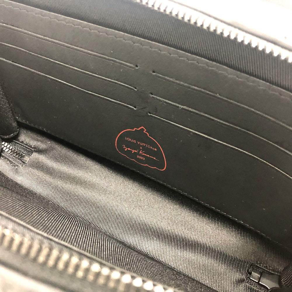 Close-up of a black bag with a brand logo on a gray background