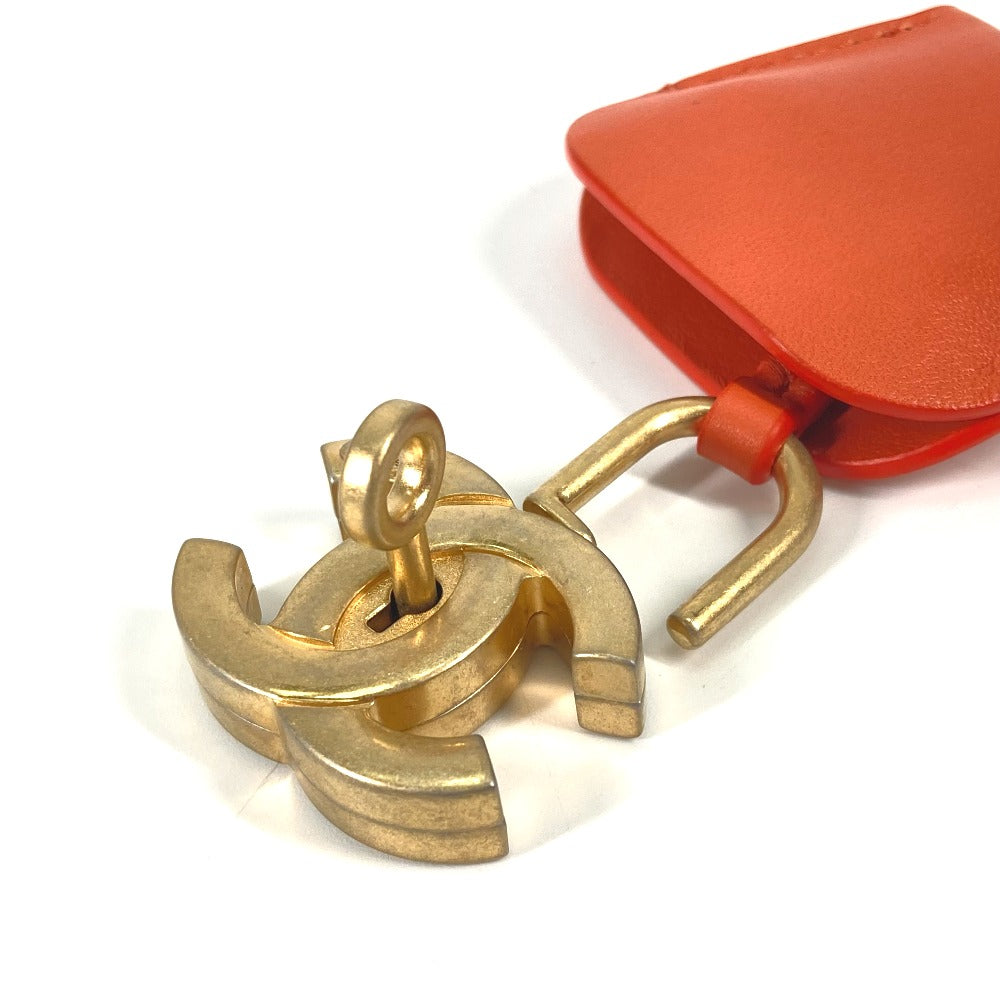 Gold CC logo earring with a red pouch on a white background