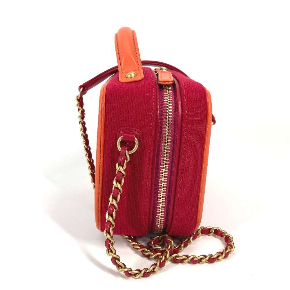 Red handbag with gold chain strap on a white background