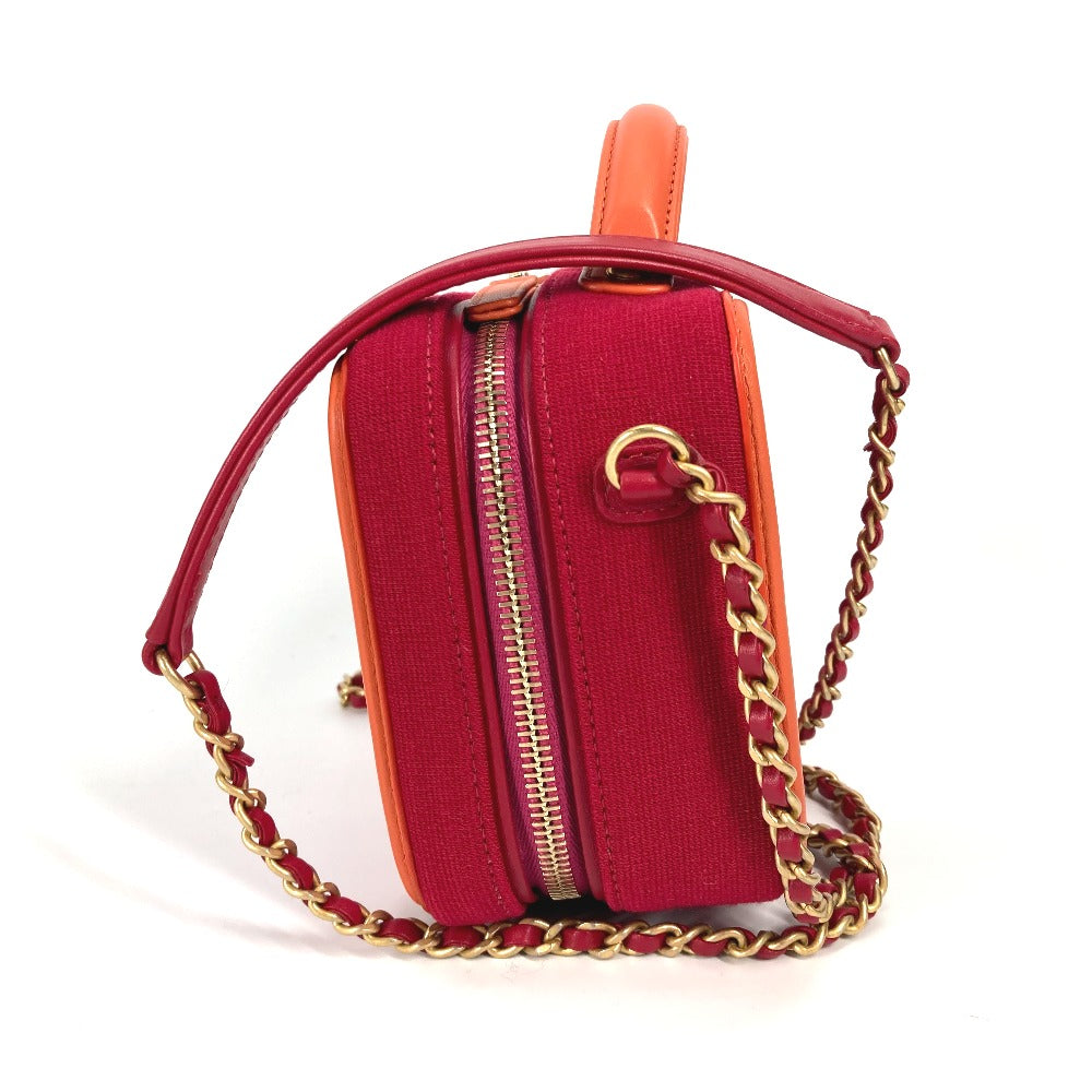 Red handbag with gold chain strap on a white background
