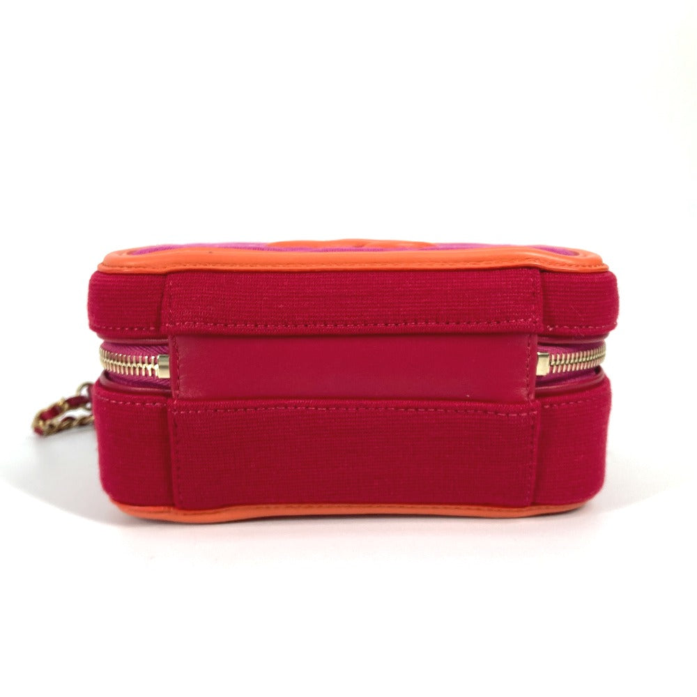 Red and orange makeup bag with gold zipper on a white background