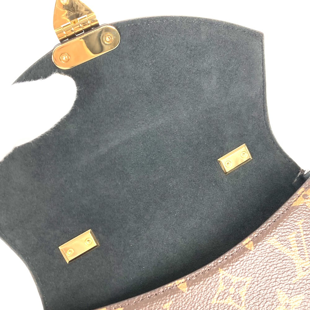 Close-up of a dark green leather bag with gold hardware on a white background