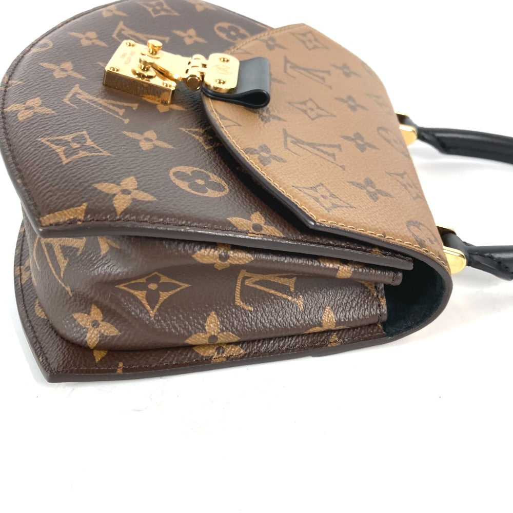 Brown handbag with gold monogram pattern on a white background