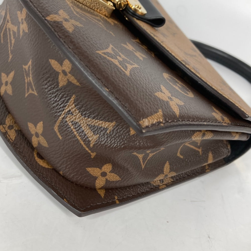 Brown handbag with a distinctive pattern on a white background