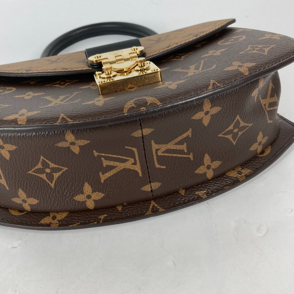 Louis Vuitton handbag with monogram pattern on a light gray background
