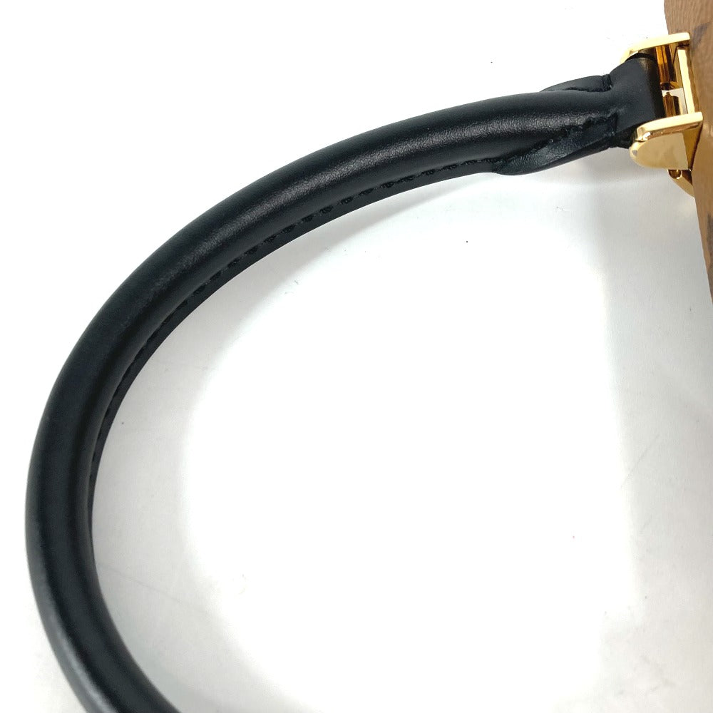 Black leather strap with gold buckle on a white background