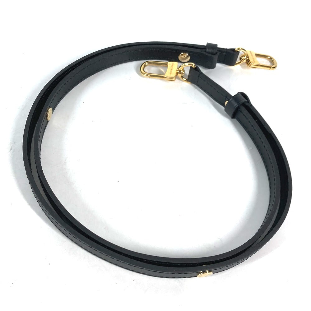 Black leather strap with gold hardware on a white background