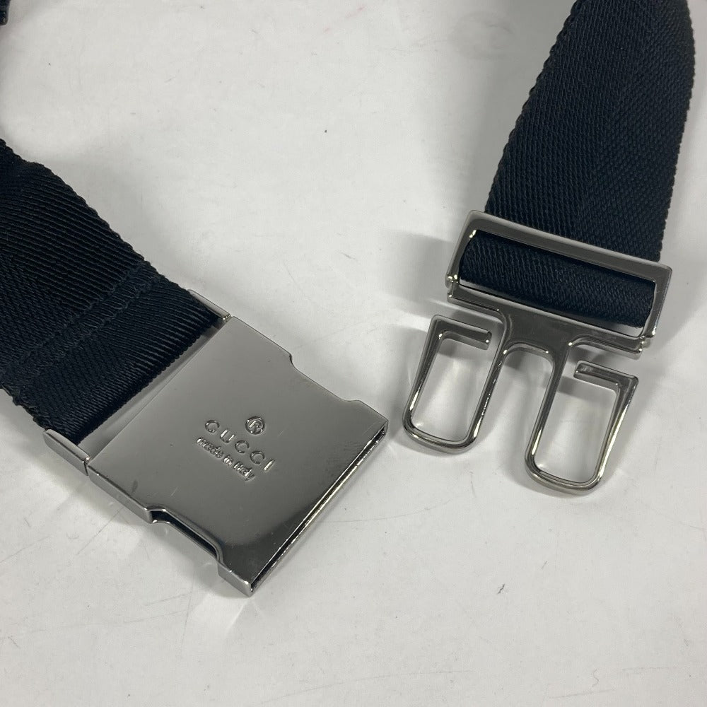 Black belt with silver buckle on a light gray background