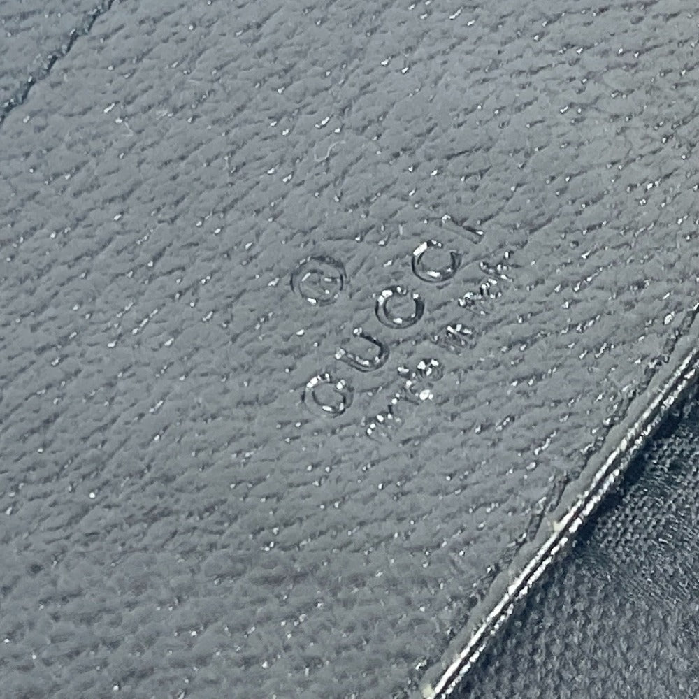 Close-up of a textured gray surface with 'Gucci' branding.