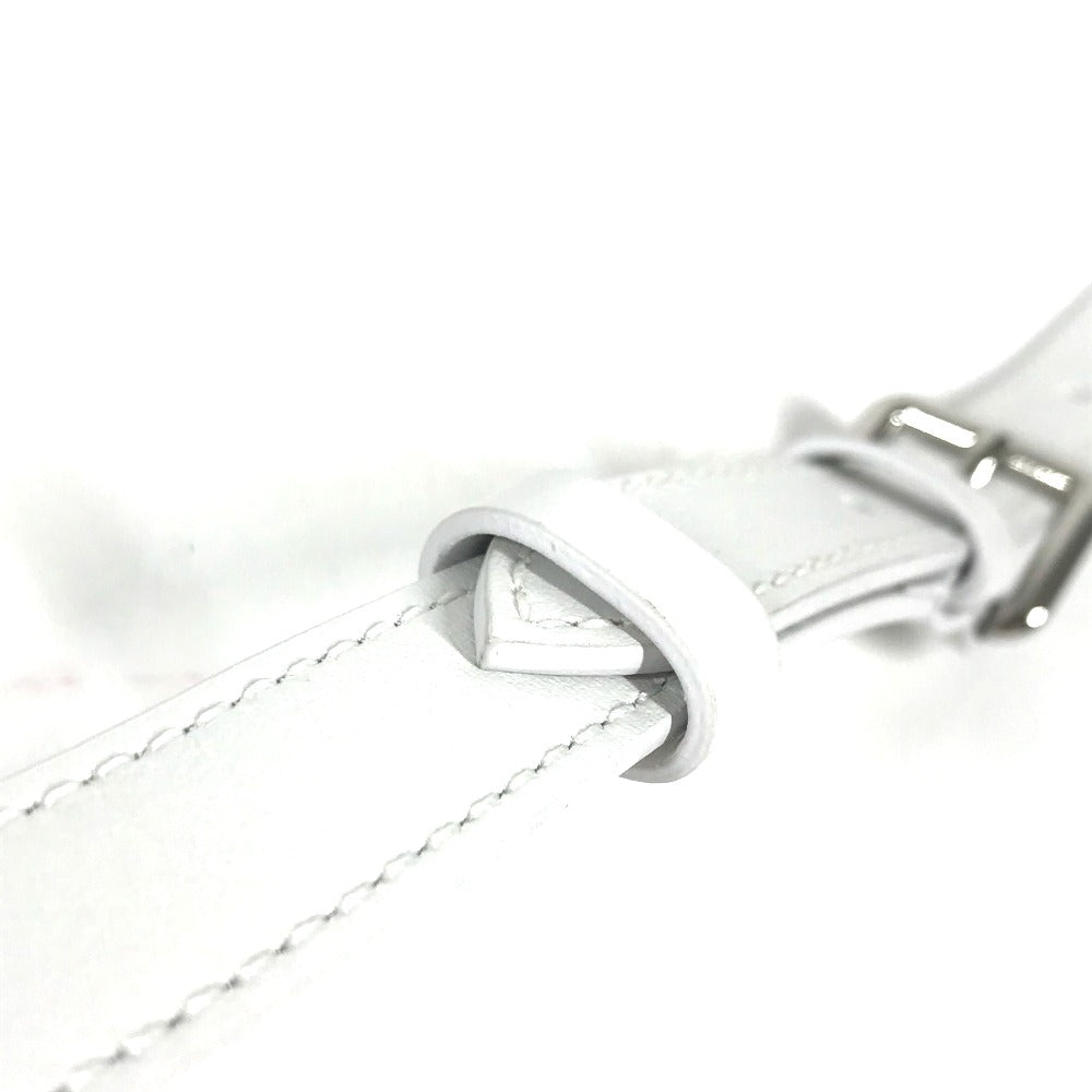 Close-up of a white leather strap with a silver buckle on a white background