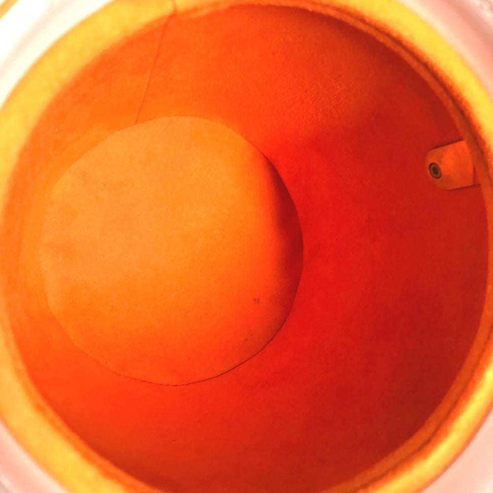 Close-up of an orange ball inside a red bucket