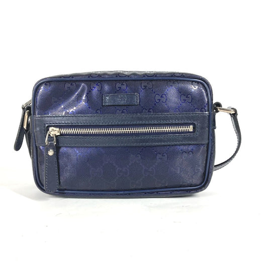 Blue handbag with a gold zipper on a white background