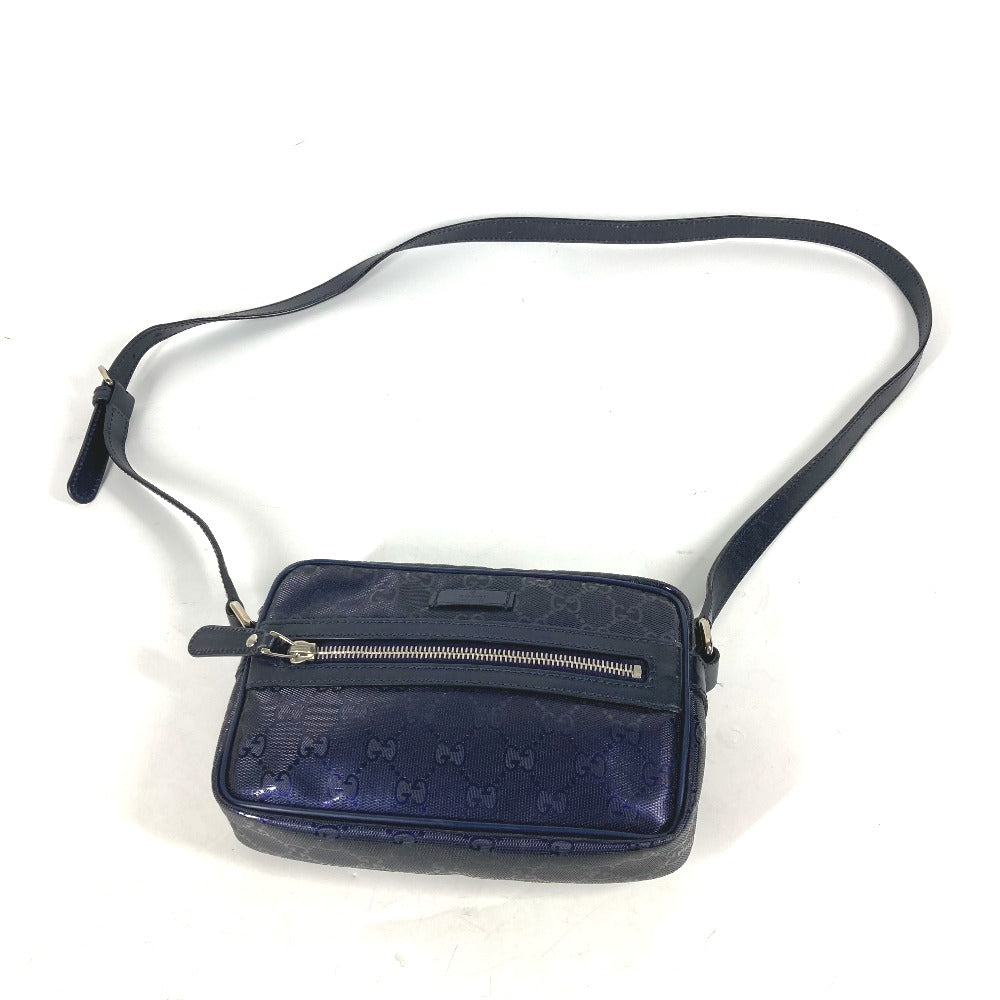 Navy blue crossbody bag with a strap on a white background