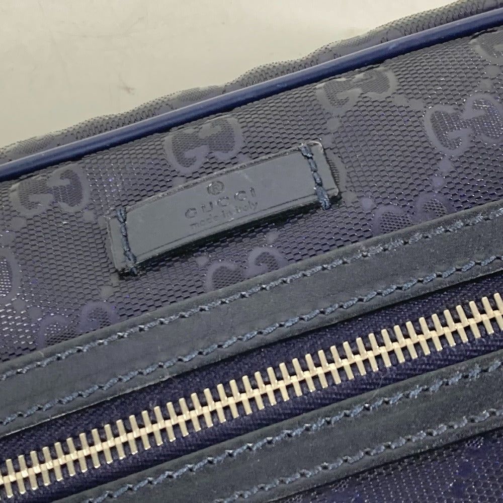 Close-up of a blue textured bag with a visible brand logo and zipper.