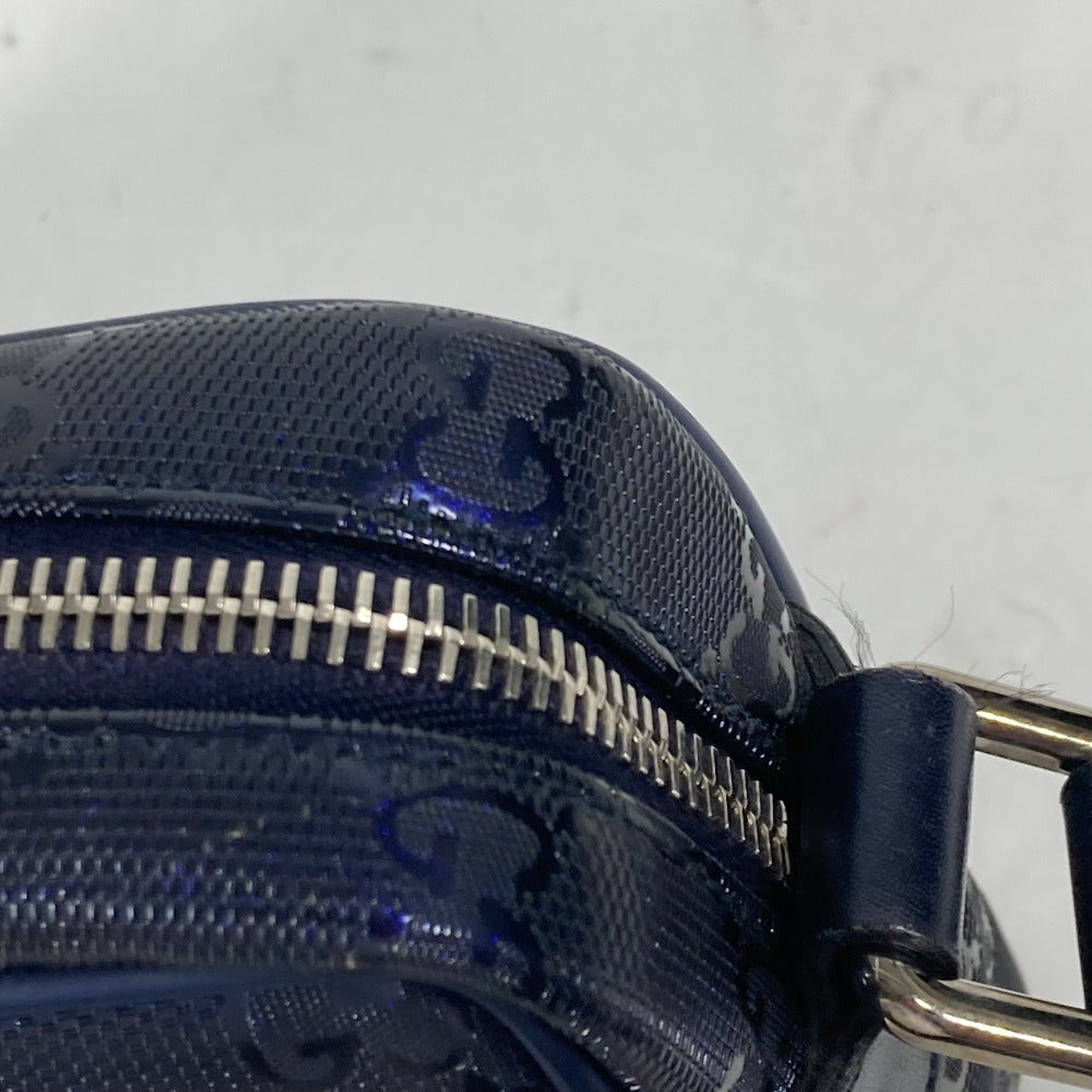Close-up of a blue textured handbag with a zipper on a light gray background
