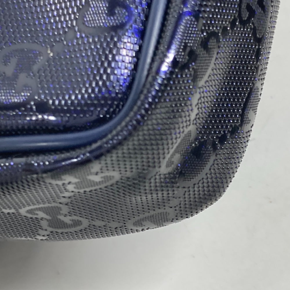 Close-up of a textured blue and silver bag with a brand logo.