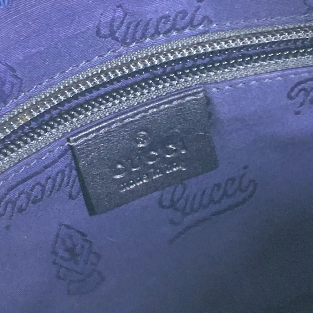 Close-up of Gucci logo and text on a blue textured surface