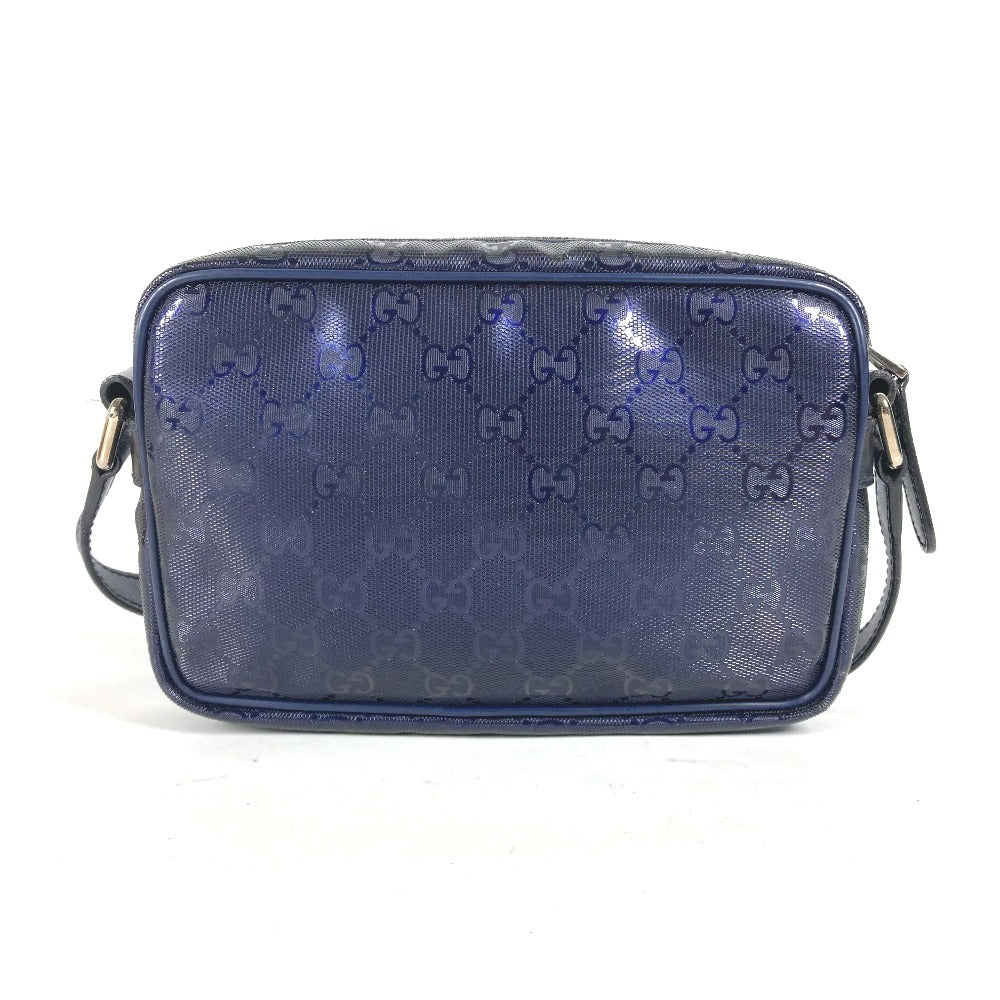 Blue Gucci handbag with signature pattern on a white background