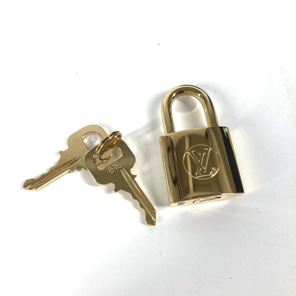 gold lock Louis Vuitton Monogram Toupie