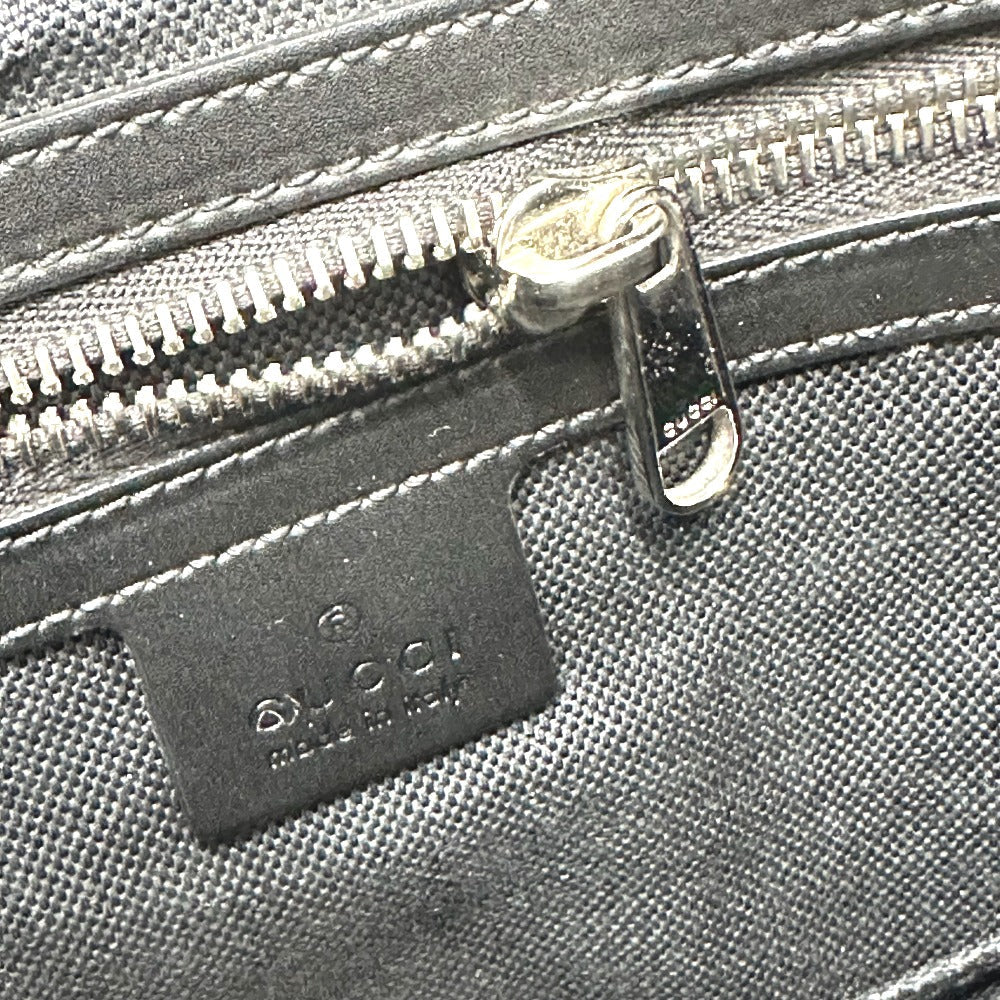 Close-up of a Gucci bag with a zipper and visible brand logo.