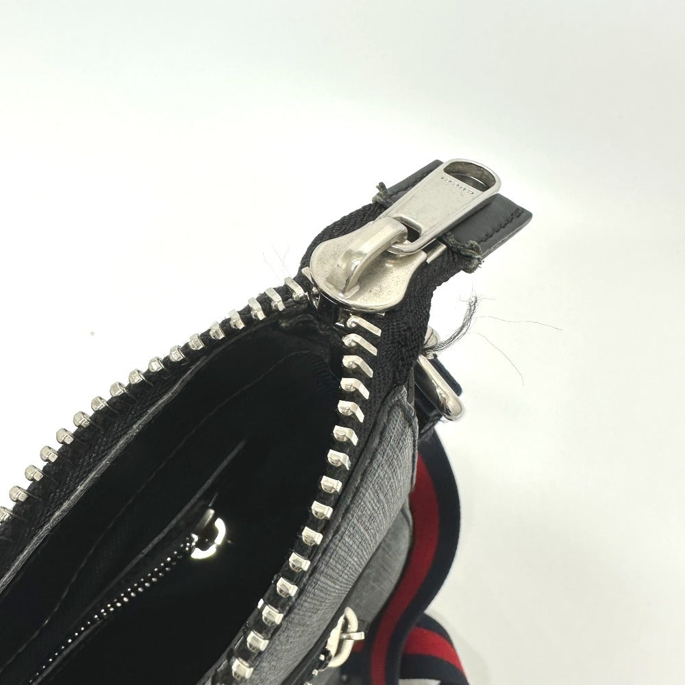 Close-up of a black leather wallet with silver zipper on a white background